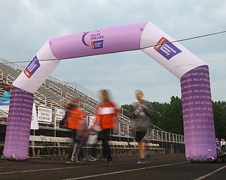 A long exposure showing groups walking under the Relay for Life Sign during the Relay for Life event at Boardman Spartan Stadium, Friday, May 19, 2017 in Boardman. ..(Nikos Frazier | The Vindicator)