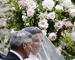 Pippa Middleton arrives with her father Michael Middleton for her wedding to James Matthews at St Mark's Church in Englefield, England Saturday, May 20, 2017. Middleton, the sister of Kate, Duchess of Cambridge is to marry hedge fund manager James Matthews in a ceremony Saturday where her niece and nephew Prince George and Princess Charlotte are in the wedding party, along with sister Kate and princes Harry and William. (AP Photo/Kirsty Wigglesworth, Pool)