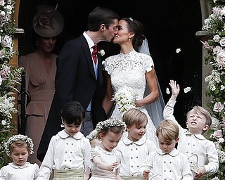 Pippa Middleton and James Matthews kiss after their wedding at St Mark's Church in Englefield, England Saturday, May 20, 2017. Middleton, the sister of Kate, Duchess of Cambridge married hedge fund manager James Matthews in a ceremony Saturday where her niece and nephew Prince George and Princess Charlotte was in the wedding party, along with sister Kate and princes Harry and William. (AP Photo/Kirsty Wigglesworth, Pool)