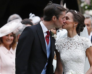Pippa Middleton and James Matthews kiss after their wedding at St Mark's Church in Englefield, England Saturday, May 20, 2017. Middleton, the sister of Kate, Duchess of Cambridge married hedge fund manager James Matthews in a ceremony Saturday where her niece and nephew Prince George and Princess Charlotte was in the wedding party, along with sister Kate and princes Harry and William. (AP Photo/Kirsty Wigglesworth, Pool)