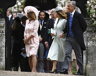 From left, Carole Middleton, Michael Middleton, the parents of Pippa Middleton,  Jane and David Matthews, the parents of James Matthews leave, after the couple's wedding, at St Mark's Church in Englefield, England Saturday, May 20, 2017. Middleton, the sister of Kate, Duchess of Cambridge married hedge fund manager James Matthews in a ceremony Saturday where her niece and nephew Prince George and Princess Charlotte was in the wedding party, along with sister Kate and princes Harry and William. (Justin Tallis/Pool Photo via AP)