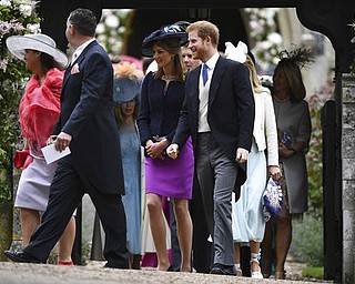 Britain's Prince Harry, right,  leaves St Mark's Church after the wedding ceremony of Pippa Middleton to James Matthews, at St Mark's Church in Englefield, England Saturday, May 20, 2017. Middleton, the sister of Kate, Duchess of Cambridge married hedge fund manager James Matthews in a ceremony Saturday where her niece and nephew Prince George and Princess Charlotte was in the wedding party, along with sister Kate and princes Harry and William. (Justin Tallis/Pool Photo via AP)