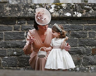 Kate, Duchess of Cambridge speaks to Princess Charlotte after the wedding of Pippa Middleton and James Matthews at St Mark's Church in Englefield, England Saturday, May 20, 2017. Middleton, the sister of Kate, Duchess of Cambridge married hedge fund manager James Matthews in a ceremony Saturday where her niece and nephew Prince George and Princess Charlotte was in the wedding party, along with sister Kate and princes Harry and William. (AP Photo/Kirsty Wigglesworth, Pool)