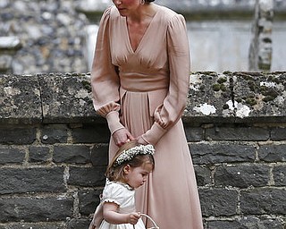 Kate, Duchess of Cambridge holds the hand of Princess Charlotte after the wedding of Pippa Middleton and James Matthews at St Mark's Church in Englefield, England Saturday, May 20, 2017. Middleton, the sister of Kate, Duchess of Cambridge married hedge fund manager James Matthews in a ceremony Saturday where her niece and nephew Prince George and Princess Charlotte was in the wedding party, along with sister Kate and princes Harry and William. (AP Photo/Kirsty Wigglesworth, Pool)