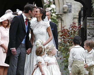 Pippa Middleton and James Matthews kiss after their wedding at St Mark's Church in Englefield, England Saturday, May 20, 2017. Middleton, the sister of Kate, Duchess of Cambridge married hedge fund manager James Matthews in a ceremony Saturday where her niece and nephew Prince George and Princess Charlotte was in the wedding party, along with sister Kate and princes Harry and William. (AP Photo/Kirsty Wigglesworth, Pool)
