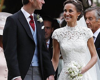 Pippa Middleton and James Matthews smile after their wedding at St Mark's Church in Englefield, England Saturday, May 20, 2017. Middleton, the sister of Kate, Duchess of Cambridge married hedge fund manager James Matthews in a ceremony Saturday where her niece and nephew Prince George and Princess Charlotte was in the wedding party, along with sister Kate and princes Harry and William. (AP Photo/Kirsty Wigglesworth, Pool)