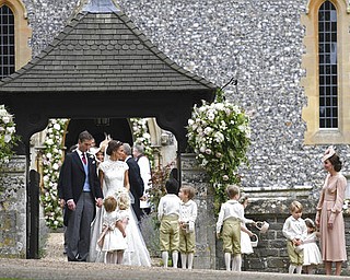Britain's Kate, the Duchess of Cambridge, right, stands with her children Prince George and Princess Charlotte, following the wedding ceremony of her sister Pippa Middleton and James Matthews, at St Mark's Church in Englefield, England Saturday, May 20, 2017. Middleton, the sister of Kate, Duchess of Cambridge married hedge fund manager James Matthews in a ceremony Saturday where her niece and nephew Prince George and Princess Charlotte was in the wedding party, along with sister Kate and princes Harry and William. (Justin Tallis/Pool Photo via AP)