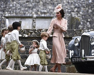 Kate, the Duchess of Cambridge, right, leads the bridesmaids and pageboys, including her son Prince George, centre and daughter Princess Charlotte, after the wedding of her sister Pippa Middleton to James Matthews, at St Mark's Church in Englefield, England Saturday, May 20, 2017. Middleton, the sister of Kate, Duchess of Cambridge married hedge fund manager James Matthews in a ceremony Saturday where her niece and nephew Prince George and Princess Charlotte was in the wedding party, along with sister Kate and princes Harry and William. (Justin Tallis/Pool Photo via AP)