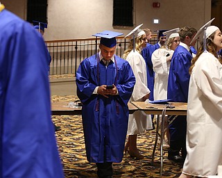 Matt Harrison plays on his phone before the Hubbard High School Commencement at Stambaugh Auditorium, Wednesday, May 24, 2017 in Youngstown.  ..(Nikos Frazier | The Vindicator)