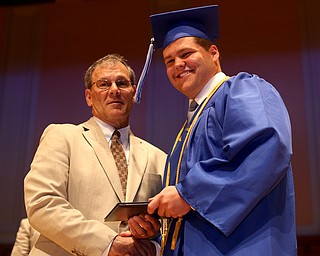 Board Member Don Newell presents Wesley Best with his diploma during the Hubbard High School Commencement at Stambaugh Auditorium, Wednesday, May 24, 2017 in Youngstown.  ..(Nikos Frazier | The Vindicator)