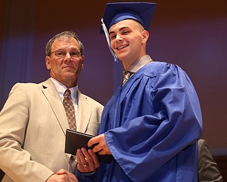 Board Member Don Newell presents Andrew Cimmento with his diploma during the Hubbard High School Commencement at Stambaugh Auditorium, Wednesday, May 24, 2017 in Youngstown.  ..(Nikos Frazier | The Vindicator)