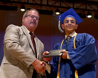 Board Member Marty Franko presents Khaled Kassem with his diploma during the Hubbard High School Commencement at Stambaugh Auditorium, Wednesday, May 24, 2017 in Youngstown.  ..(Nikos Frazier | The Vindicator)