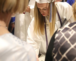 Amanda Schultz searches for her diploma after the Hubbard High School Commencement at Stambaugh Auditorium, Wednesday, May 24, 2017 in Youngstown.  ..(Nikos Frazier | The Vindicator)