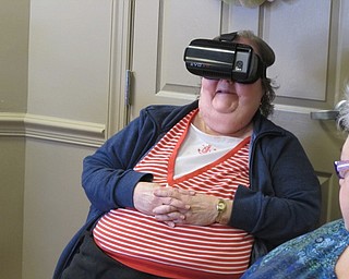 Neighbors | Alexis Bartolomucci.Mary, one of the residents at the Commons at Greenbriar, went on a rollercoaster using virtual reality on April 18.