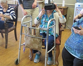 Neighbors | Alexis Bartolomucci.Mary Nicolli, resident at Commons at Greenbriar, tested out the virtual reality set on April 18 and took a tour of the Eiffel Tower.