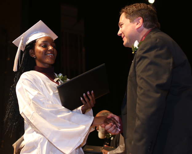 Kia Allen shakes Superintendent Steve Chiaro's hand after receiving her diploma during the Warren G. Harding High School Commencement at W.D. Packard Music Hall, Thursday, May 25, 2017 in Warren.  ..(Nikos Frazier | The Vindicator)
