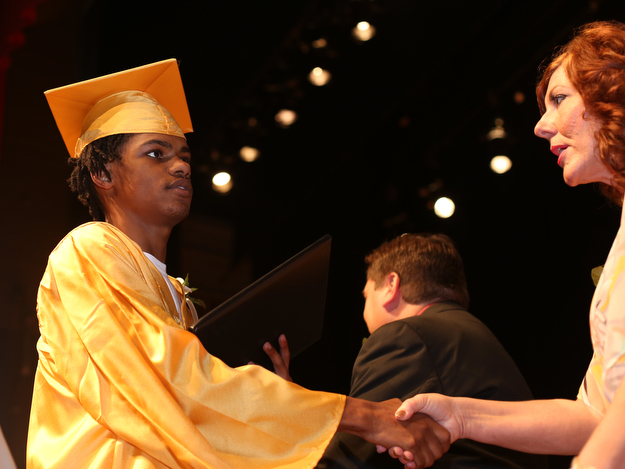 Tay'Jhon Baugh shakes board member Patricia M. Limperos's hand after receiving his diploma during the Warren G. Harding High School Commencement at W.D. Packard Music Hall, Thursday, May 25, 2017 in Warren.  ..(Nikos Frazier | The Vindicator)