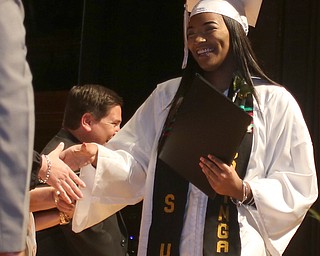 Lauryn Honeywood shakes a board members hand after receiving her diploma during the Warren G. Harding High School Commencement at W.D. Packard Music Hall, Thursday, May 25, 2017 in Warren.  ..(Nikos Frazier | The Vindicator)