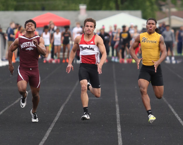 Warren Harding's Kayron Adams(180)(right) competes in the boys 100 meter dash final during the Division 1 Region 1 Track & Field Championships, Friday, May 26, 2017 at Austintown High School in Austintown...Running next to him are, Chardon's Joey Dinko(2)(center) and Maple Heights' Brandon Adams(671)...(Nikos Frazier | The Vindicator)..