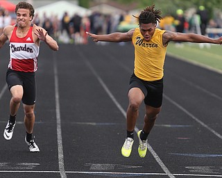 Warren Harding's Kayron Adams(180)(right) finishes in the boys 100 meter dash final during the Division 1 Region 1 Track & Field Championships, Friday, May 26, 2017 at Austintown High School in Austintown...Running next to him are, Chardon's Joey Dinko(2)(left)...(Nikos Frazier | The Vindicator)..