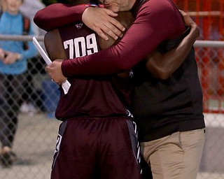 Boardman's Chris Butler(709) hugs his coach after completing the rerun of the boys 1600 meter run final during the Division 1 Region 1 Track & Field Championships, Friday, May 26, 2017 at Austintown High School in Austintown. ..(Nikos Frazier | The Vindicator)..