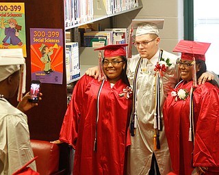        ROBERT K. YOSAY  | THE VINDICATOR..The last class of VPA/Stem Graduated at Chaney High School Friday afternoon ..Ò..Twins....Zachery Wright -  is between  the Asia Coder and Tasia Coder--- pose as a last friends photo
