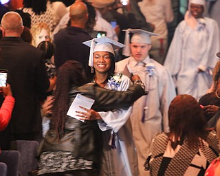        ROBERT K. YOSAY  | THE VINDICATOR..Pride emanated from the Stambaugh Auditorium Friday morning as 189 East High students celebrated their last hurrah of high school.- Jim Tressel main speaker.Ò..Getting a congratulatory hug as the class enters the auditorium from her Grand Mother  Ke'Laya Tra-Nee Banks