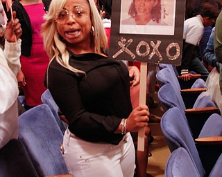        ROBERT K. YOSAY  | THE VINDICATOR..Pride emanated from the Stambaugh Auditorium Friday morning as 189 East High students celebrated their last hurrah of high school.- Jim Tressel main speaker.Ò..congratulations for Marvinia Fulks  from her aunt Stephanie Matthews