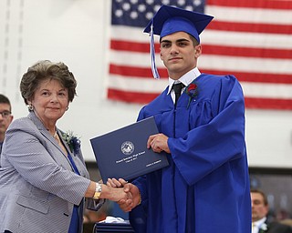Dominic Drummond shakes board member Elinor Zedaker's hand after receiving his diploma during the Poland Seminary High School Graduation, Saturday, May 27, 2017 in Poland...(Nikos Frazier | The Vindicator)