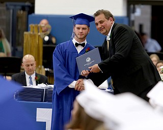 Anthony Mamonis shakes board member Larry Dinopoulos's hand after receiving his diploma during the Poland Seminary High School Graduation, Saturday, May 27, 2017 in Poland...(Nikos Frazier | The Vindicator)