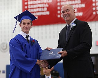 David Stebelton shakes board member Richard Weaver's hand after receiving his diploma during the Poland Seminary High School Graduation, Saturday, May 27, 2017 in Poland...(Nikos Frazier | The Vindicator)