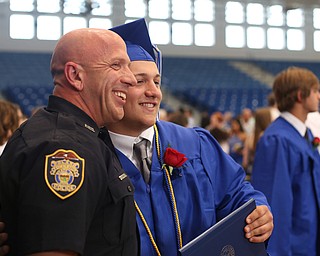 Nick Petrolla poses for a photo with Officer Steve Kent after the Poland Seminary High School Graduation, Saturday, May 27, 2017 in Poland...(Nikos Frazier | The Vindicator)