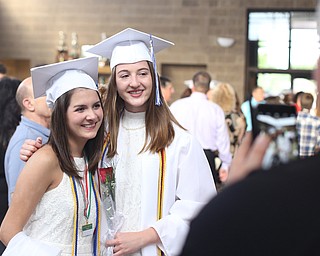 Nora Hernon(left) and Avery Blasko pose for photos after the Poland Seminary High School Graduation, Saturday, May 27, 2017 in Poland...(Nikos Frazier | The Vindicator)