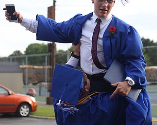 Kyle McCree lifts Reid Gould after the Poland Seminary High School Graduation, Saturday, May 27, 2017 in Poland...(Nikos Frazier | The Vindicator)