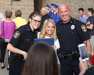 Carlei Lattanzio(center) poses for photos with Officer Julie Henderson(left) and Officer Steve Kent(right) after the Poland Seminary High School Graduation, Saturday, May 27, 2017 in Poland...(Nikos Frazier | The Vindicator)