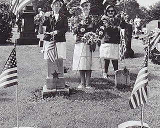 Placing wreaths at the Civil War soldiers' plot in Oak Hill Cemetery were (left to right) Anna Rauch, past president of the Daughters of Union Veterans; Marian Phillips, president of the auxiliary to Sons of Union Veterans of the Civil War, and Patricia Phillips.