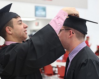 Tyler Kern gets help with his mortarboard from Gino Bionci before the Struthers High School Graduation, Sunday, May 28, 2017 in Struthers...(Nikos Frazier | The Vindicator)