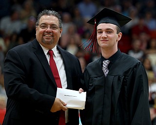Stephan Heasley receives his diploma from board president Ron Shives during the Struthers High School Graduation, Sunday, May 28, 2017 in Struthers...(Nikos Frazier | The Vindicator)