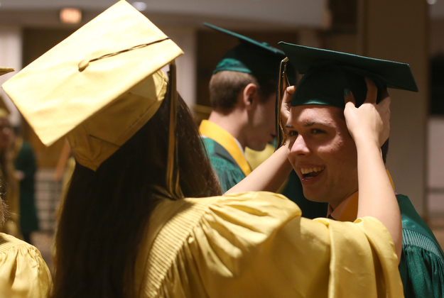Yeseni Pezel adjusts Joesph Koewacich's mortarboard before the Ursuline High School Graduation at Stambaugh Auditorium, Sunday, May 28, 2017 in Youngstown...(Nikos Frazier | The Vindicator)