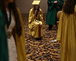 Jennifer Woodford uses her phone before the Ursuline High School Graduation at Stambaugh Auditorium, Sunday, May 28, 2017 in Youngstown...(Nikos Frazier | The Vindicator)
