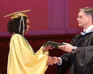 Malayja Jackson receives her diploma from Principal Matthew Sammartino during the Ursuline High School Graduation at Stambaugh Auditorium, Sunday, May 28, 2017 in Youngstown...(Nikos Frazier | The Vindicator)