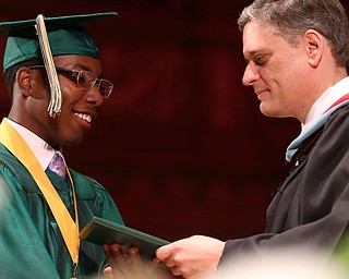 Michael Harris receives his diploma from Principal Matthew Sammartino during the Ursuline High School Graduation at Stambaugh Auditorium, Sunday, May 28, 2017 in Youngstown...(Nikos Frazier | The Vindicator)