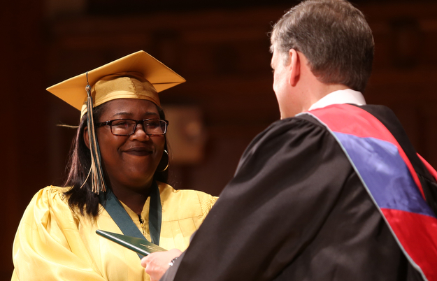 Taysia Miller receives her diploma from Principal Matthew Sammartino during the Ursuline High School Graduation at Stambaugh Auditorium, Sunday, May 28, 2017 in Youngstown...(Nikos Frazier | The Vindicator)