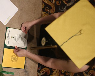 Paige Freisen puts her diploma in its book after the Ursuline High School Graduation at Stambaugh Auditorium, Sunday, May 28, 2017 in Youngstown...(Nikos Frazier | The Vindicator)
