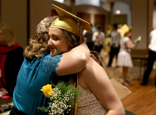 Kali Kerpelis hugs her religion teacher Cindy Lacklo after the Ursuline High School Graduation at Stambaugh Auditorium, Sunday, May 28, 2017 in Youngstown...(Nikos Frazier | The Vindicator)