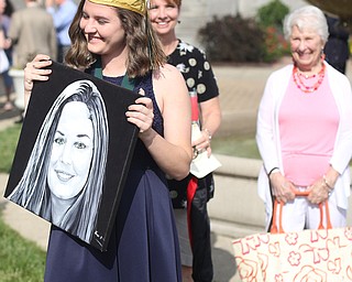 Carli Koewacich poses with a painting of her from her grandmother, Nancy Bielik(background) after the Ursuline High School Graduation at Stambaugh Auditorium, Sunday, May 28, 2017 in Youngstown...(Nikos Frazier | The Vindicator)