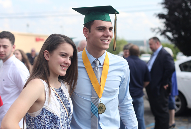 Vince Venzeio poses for a photo with his cousin Madison Massuri after the Ursuline High School Graduation at Stambaugh Auditorium, Sunday, May 28, 2017 in Youngstown...(Nikos Frazier | The Vindicator)