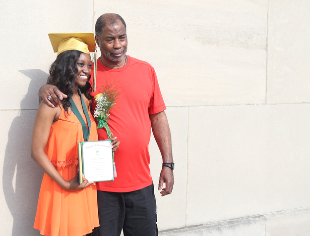 La-Tonya Martin and her grandfather, Jessie Martin pose for photos after the Ursuline High School Graduation at Stambaugh Auditorium, Sunday, May 28, 2017 in Youngstown...(Nikos Frazier | The Vindicator)