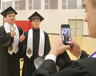 William D. Lewis The Vindicator Girard grads Hayden MAderitz, left, and Dakota Mccloskey pose as fellow grad Nick Hall snaps a photo before 5-28-17 commencement at Girard HS.