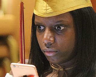 William D. Lewis The Vindicator Mooney grad Taylor Javey texts her mother  before 5-28-17 commencement at Stambaugh Auditorium.